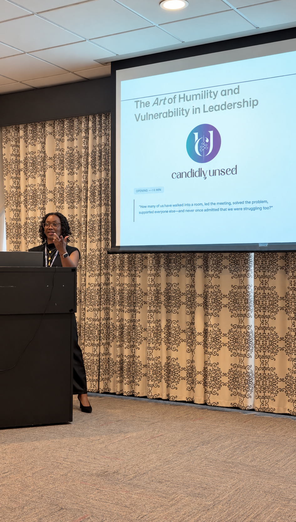 Zormarah “Zhee” Lyda speaking at a podium beside a screen reading “The Art of Humility and Vulnerability in Leadership” at the RBLP 2026 Conference